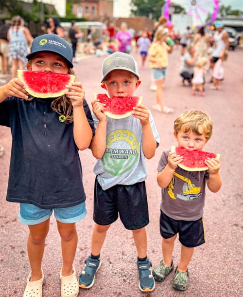 kids eating watermelon at fair