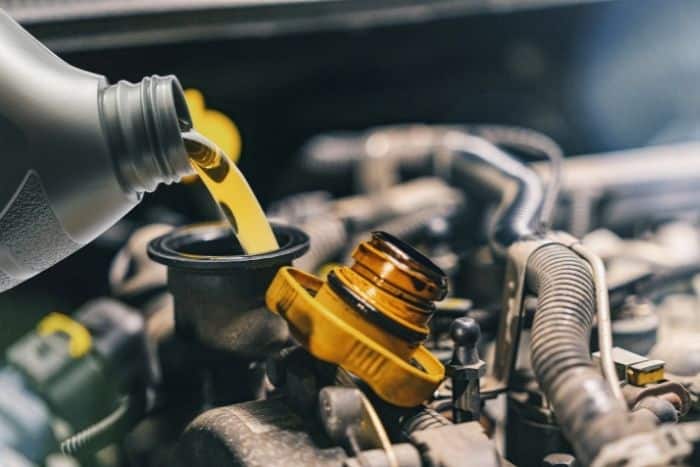 Oil being poured into vehicle during oil change