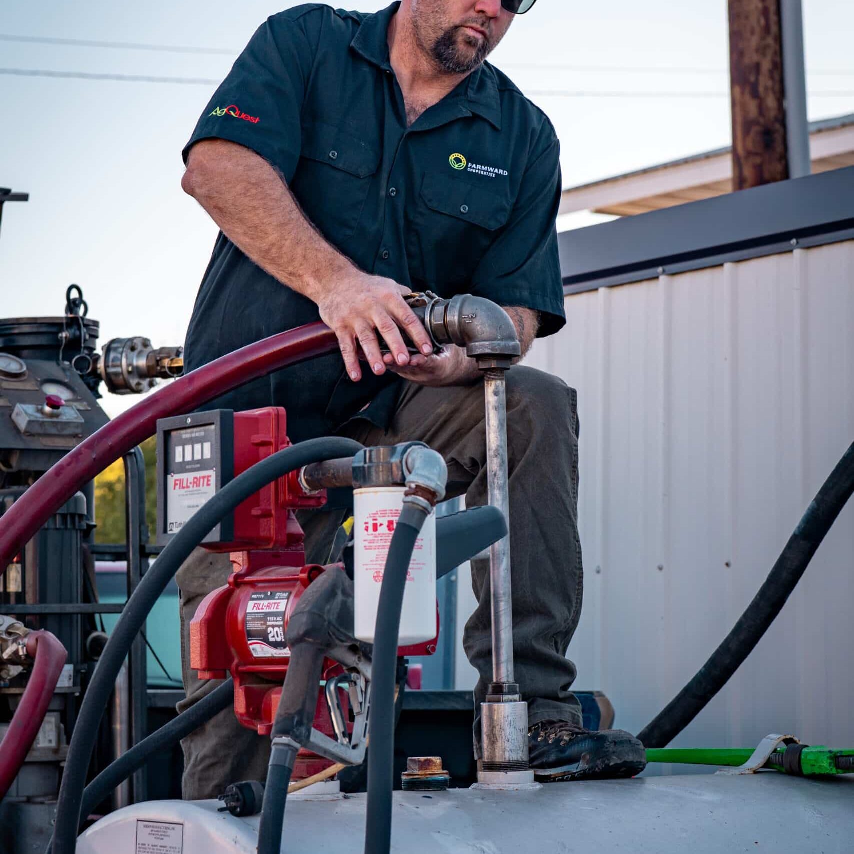 Farmward employee cleaning fuel tank