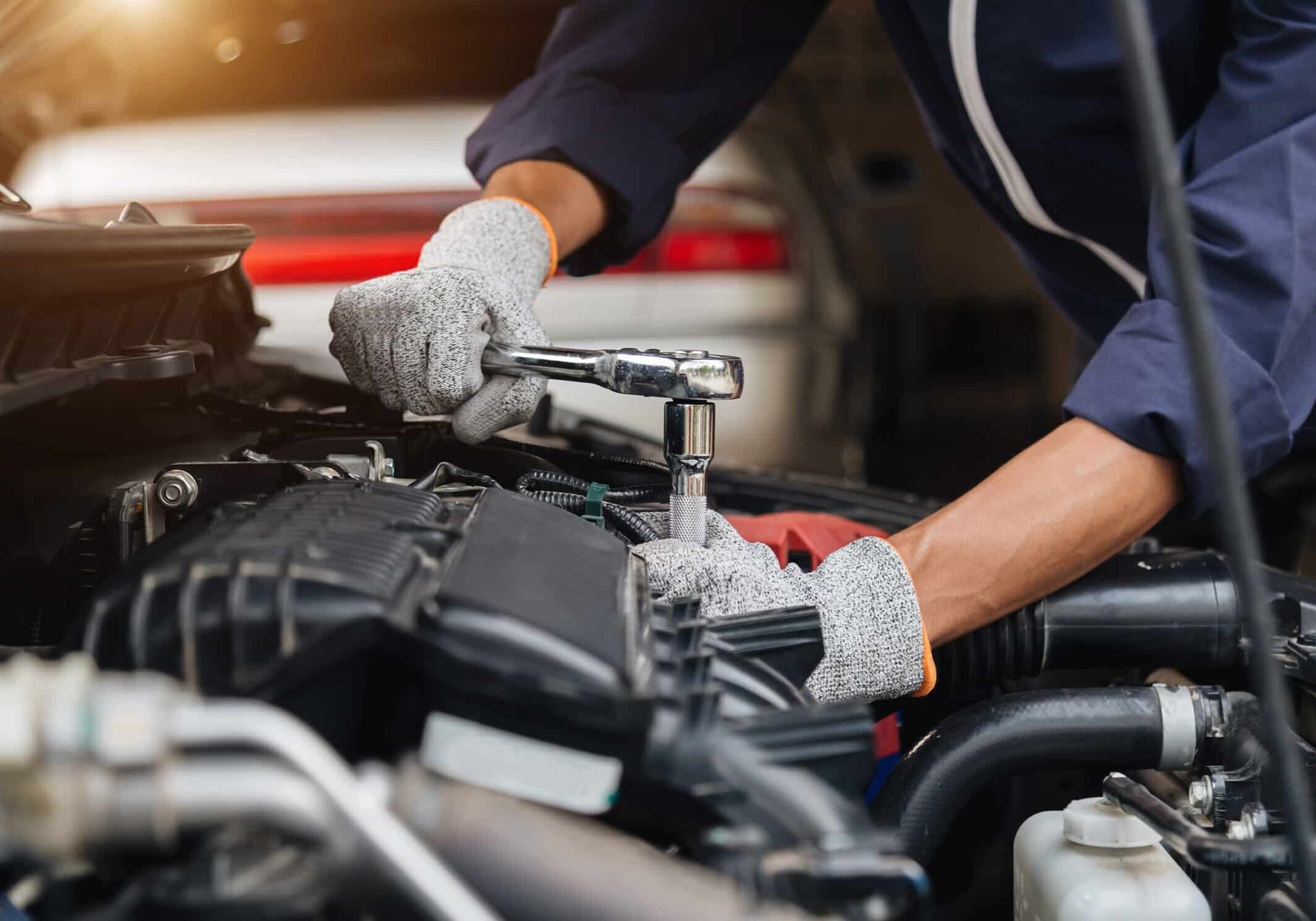 automobile mechanic repairman hands repairing a car engine autom