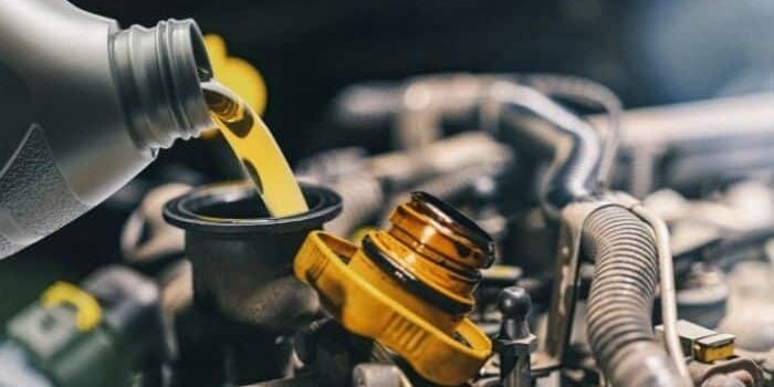 Oil being poured into vehicle during oil change