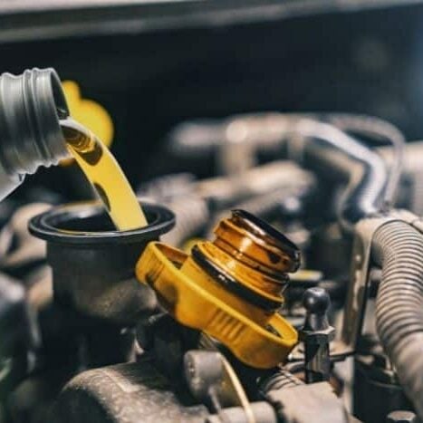Oil being poured into vehicle during oil change