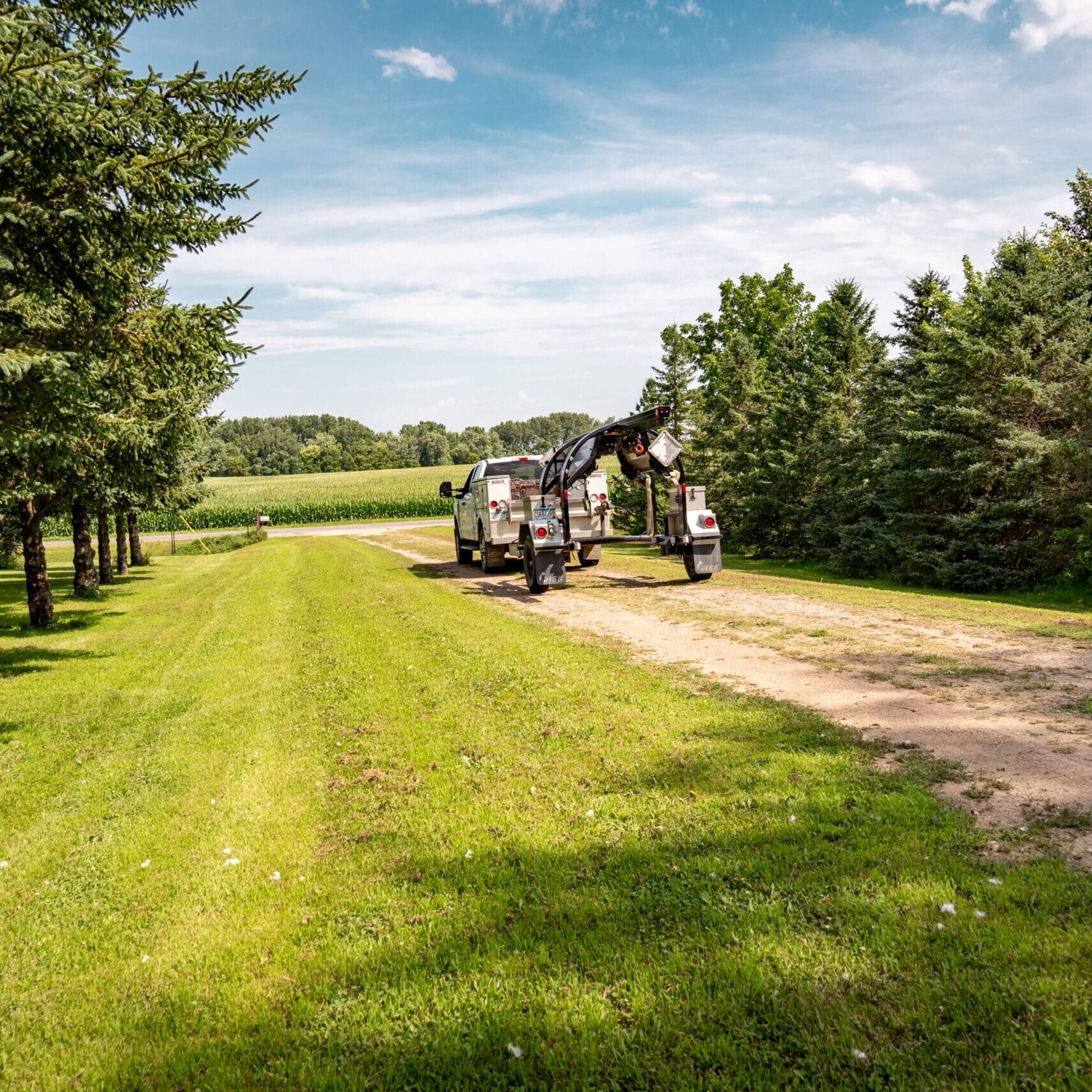 propane tank leveling on the road with green grass and blue sky