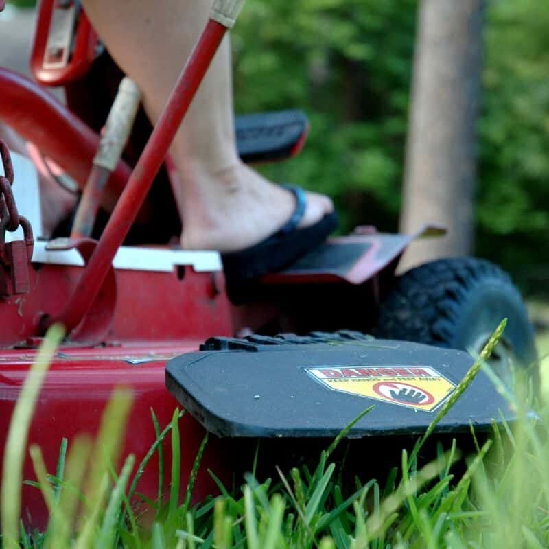 person riding on lawn mower